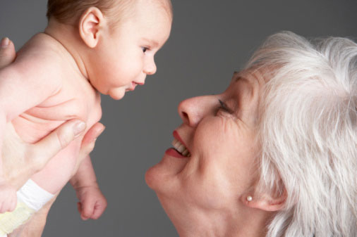 older adult holding baby