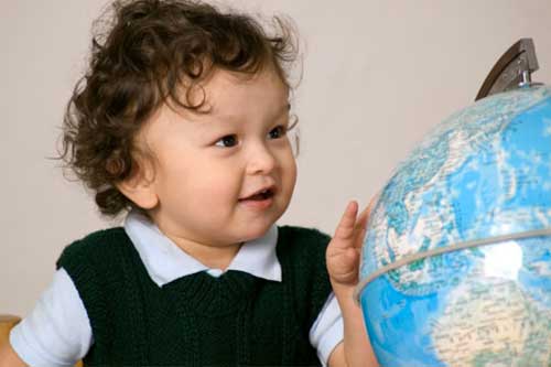 child beside globe
