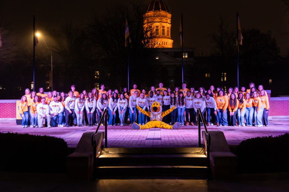 a group of people standing with Truman the Tiger